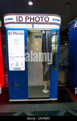 SINGAPORE - CIRCA APRIL, 2019: ID photo booth seen in Singapore at night. A photo booth is a vending machine or kiosk which contains an automated came Stock Photo