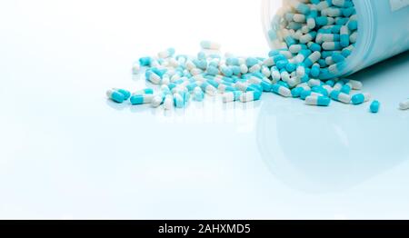 Blue-white antibiotic capsule pill and capsule pills bottle. Antibiotic drug resistance. Pharmaceutics concept. Pharmaceutical industry. Pharmacy Stock Photo