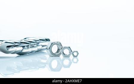 Metal hexagon nuts and chrome wrenches isolated on white background. Mechanic tools for maintenance. Hardware tool. Fastener with a threaded hole. Set Stock Photo