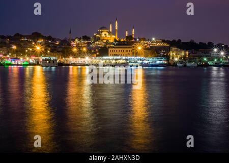 Süleymaniye Mosque, Süleymaniye Camii, located on a hill in Fatih district, seen from Galata Bridge, Galata Köprüsü, illuminated at night Stock Photo