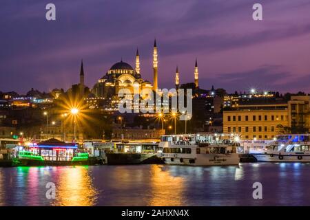 Süleymaniye Mosque, Süleymaniye Camii, located on a hill in Fatih district, seen from Galata Bridge, Galata Köprüsü, illuminated at night Stock Photo