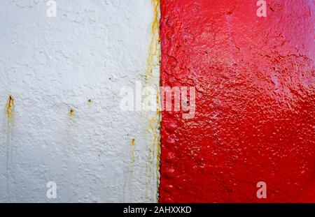 weathered red and white painted metal marker buoy Stock Photo