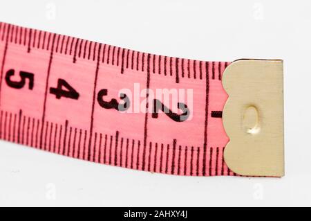 Pink tape measure roll isolated on the white background Stock Photo - Alamy