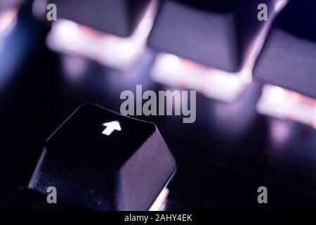 a close-up view of black mechanical pc keyboard with white backlight. Stock Photo