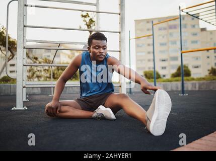 Health, fitness and black man stretching legs outdoors on city rooftop  alone. Sports, training and male athlete warm up, preparing and getting  ready for workout, running or exercise for wellness.