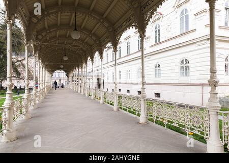 Karlovy Vary, Czech Republic - May 5, 2017: People walk the Gallery with mineral water