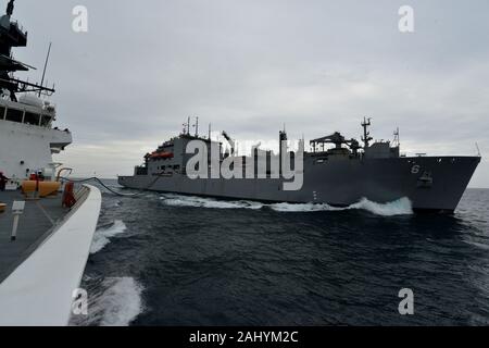 U.S. Coast Guard Cutter Bertholf (WMSL 750) transits alongside the USNS Amelia Earhart (T-AKE 6) while receiving fuel during an underway replenishment in the East China Sea, March 29, 2019. U.S. Coast Guard’s deployment of resources to the region, including the Bertholf, directly supports U.S. Foreign Policy and National Security objectives as outlined by the President in the Indo-Pacific Strategy and the National Security Strategy. U.S. Coast Guard photo by Petty Officer 1st Class Matthew S. Masaschi. Stock Photo