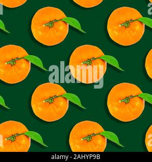 seamless background from ripe tangerines isolated on green background. christmas Stock Photo