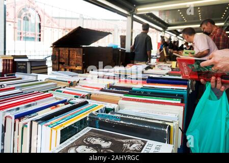 BARCELONA, SPAIN - JULY 15, 2018: Customers at the stalls of the secondhand book market at the Mercat de Sant Antoni public market in Barcelona, Spain Stock Photo