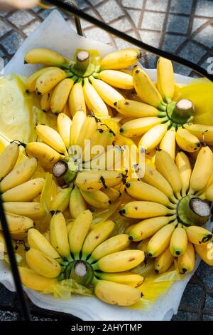 Vietnam: Ho Chi Minh City (Saigon). Yellow bananas on a merchant's stall in the downtown market near the central post office Stock Photo