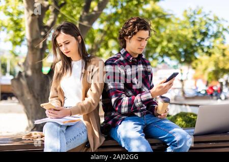 Couple not talking to each other typing on mobile phones Stock Photo