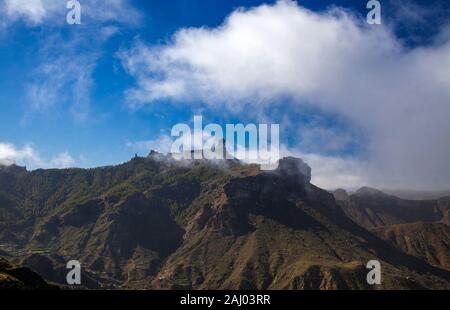 Gran Canaria, December, relatively wet season, clouds blowing across Caldera de Tejeda, iconic Roque Nublo half hidden by the low clouds Stock Photo