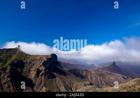 Gran Canaria, December, relatively wet season, clouds blowing across Caldera de Tejeda, iconic Roque Nublo to the left half hidden in the clouds, Roqu Stock Photo