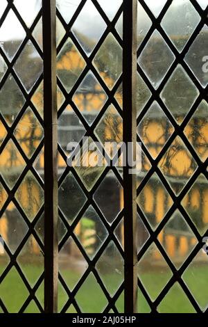 Stokesay castle half timbered gatehouse viewed through one of the leaded windows of the castle. Stock Photo