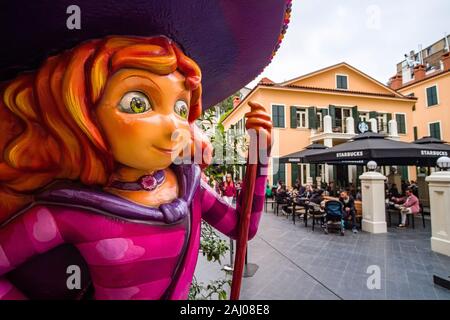 A colorful sculpture of a girl with red hair and a big hat in front of a Starbucks Coffee shop in the suburb Karaköy Stock Photo