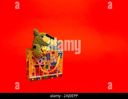 Gift for Valentine's Day. Christmas present. Toy in festive packaging on a bright background. Place for text. Stock Photo