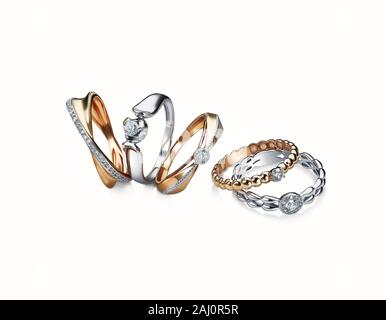 group of diamond rings stacked isolated on white background, white gold, yellow gold, included clipping path. extreme close up. Stock Photo