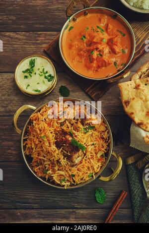 Indian meal / Restaurant menu concept - Mutton biryani, butter chicken, Roti and raita background Stock Photo