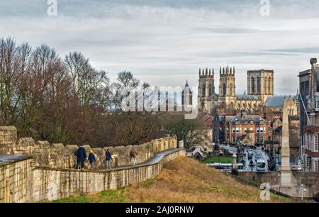 YORK ENGLAND THE CITY WALLS AND WALKERS LOOKING TOWARDS THE MINSTER AND THE TOWER OF ST WILFRIDS CATHOLIC CHURCH Stock Photo