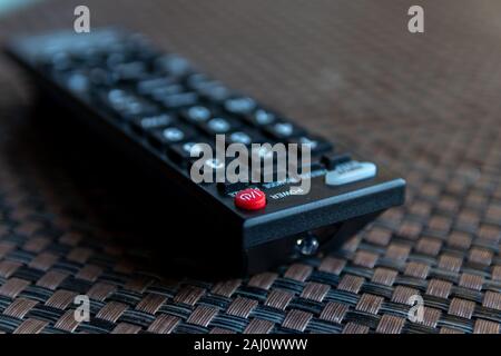 TV remote control without brand name with selective focus on red power button Stock Photo