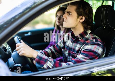 Beautiful couple having an argument in the car while driving Stock Photo