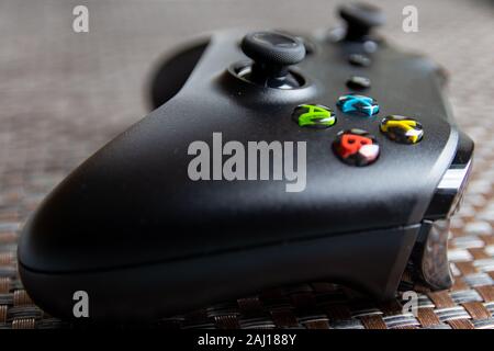 No brand black game controller on textured surface Stock Photo