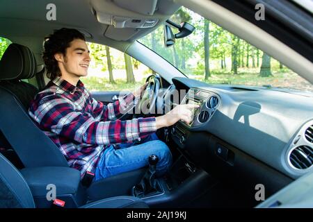 transportation and vehicle concept - man using car audio stereo system Stock Photo