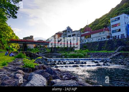 People sitting beside Hayakawa River at Hakone, Japan Stock Photo