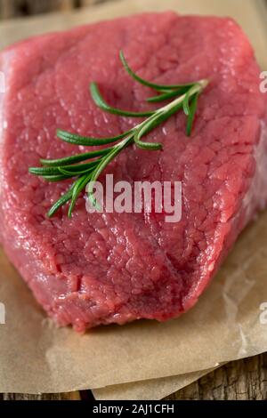raw steak on wooden surface Stock Photo