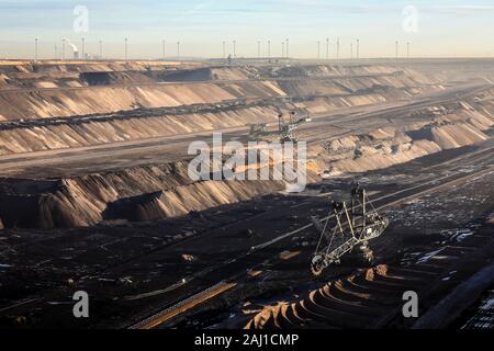 Juechen, North Rhine-Westphalia, Germany - Bucket wheel excavator in the RWE opencast lignite mine Garzweiler, Rhenish lignite mining area. Wind turbi Stock Photo