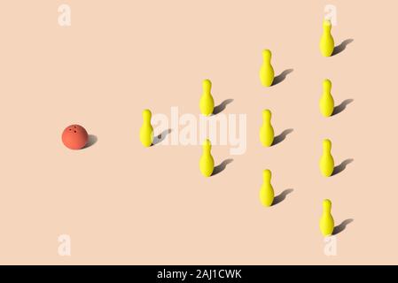 Red bowling ball and yellow bowling pins on pastel background sport abstract. Stock Photo