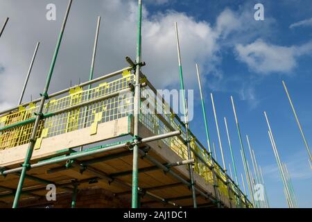 Close up detail of scaffolding with brick guards and toe boards on a UK housebuilding site Stock Photo