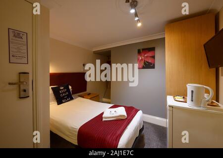 Interior of a single bedroom in a budget hotel in Hammersmith London UK Stock Photo