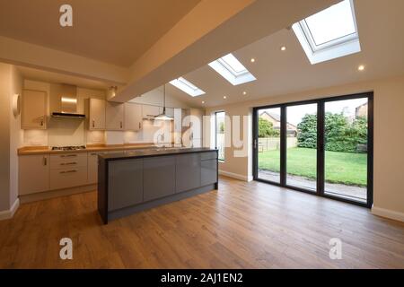 A modern open plan kitchen dining living room rear extension to a property in Chester with bifold doors and velds skylights Stock Photo