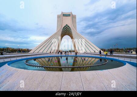 Azadi Tower or Borj-e Azadi tower or Freedom Monument formerly known as Shahyad Tower and cultural complex reflecting in a pond, Tehran, Islamic Repub Stock Photo