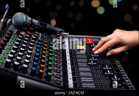 Woman hands mixing audio by sound mixer analog in the recording studio Stock Photo