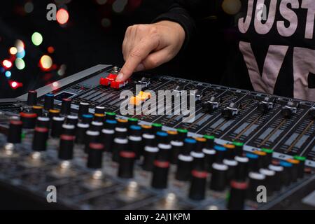 Woman hands mixing audio by sound mixer analog in the recording studio Stock Photo