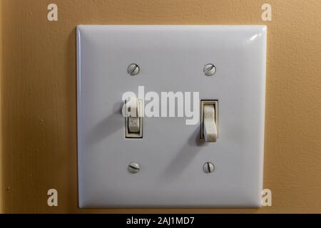 Two light switches showing on and off Stock Photo
