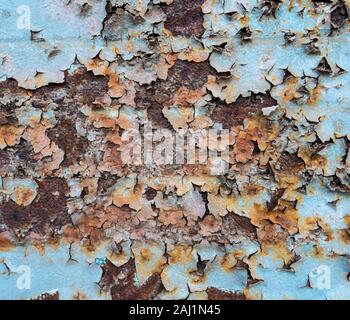 Peeling paint on rusty garage door close to the sea. Stock Photo