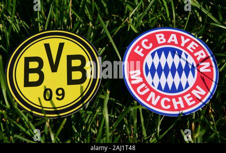 September 6, 2019, Munich, Germany. Emblems of German football clubs Bayern Munich and Borussia Dortmund on the green lawn Stock Photo