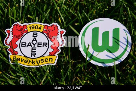 September 6, 2019, Munich, Germany. Emblems of German football clubs Bayer Leverkusen and VfL Wolfsburg on the green lawn Stock Photo