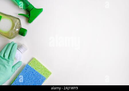 Detergents and cleaning accessories on a green background. Housekeeping  concept Stock Photo - Alamy