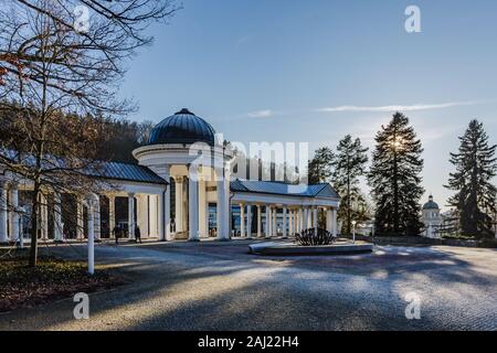 Marianske Lazne, Czech Republic - January 1 2020: View of Rudolph Spring Pavilion at colonnade with frozen ground during winter time. Bright blue sky. Stock Photo