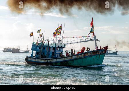 A fishing trawler at sea, taking part in the annual whale festival, with a lion dance on deck and other boats in the background, Vietnam, Asia Stock Photo