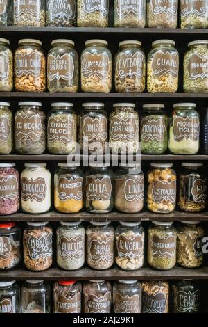 Jars on a store shelf labled with various spices. Stock Photo