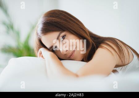 Beautiful girl sleeps in the bedroom, lying on bed Stock Photo