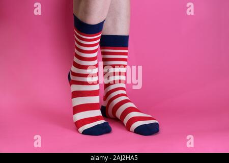 striped bright socks on a pink background. fashion bright funny socks Stock Photo