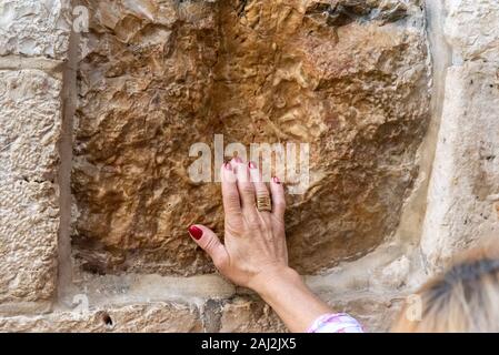 Hand on holy stone in Jerusalem, Israel. Stock Photo