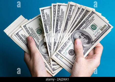 girl hands holding a batch of dollars Stock Photo