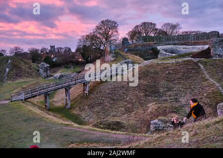 Dramatic vivid December sunset over the 11th century ruins of the Castle Acre fortifications in Norfolk England Stock Photo